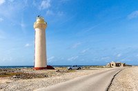Pickup truck parked next to the historic Willemstoren Lighthouse