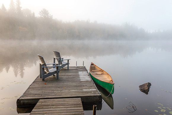 Green Canoe and Dock on a Misty Morning