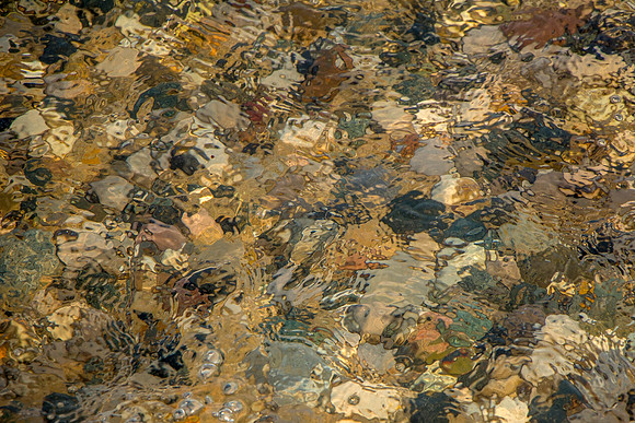 Water Washing Over Pebbles on a Beach Creating an  Colorful Abst