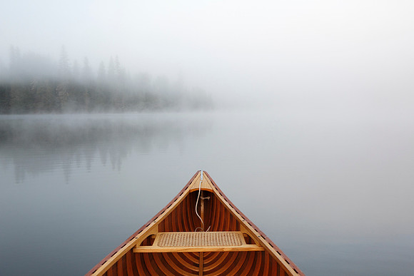 Canoeing on a Misty Lake